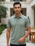 Man wearing a light green polo shirt standing outdoors.