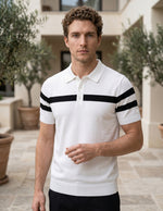Man wearing a white polo shirt with black stripes outdoors