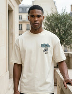 Man wearing a white t-shirt with a graphic design in an urban setting