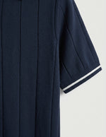 Navy blue coat with white trim on a light gray background