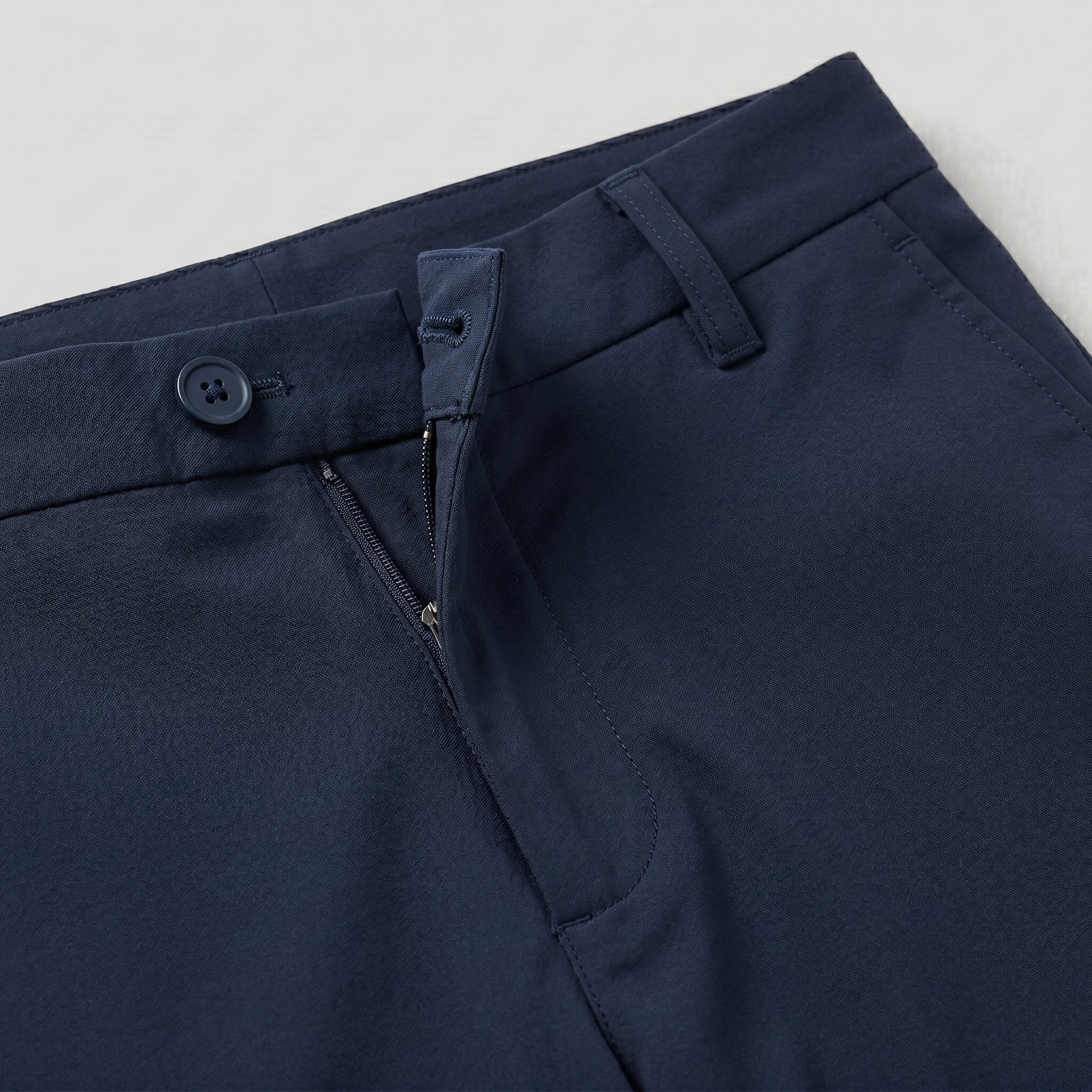Navy blue men’s stretch straight-leg trousers close-up details