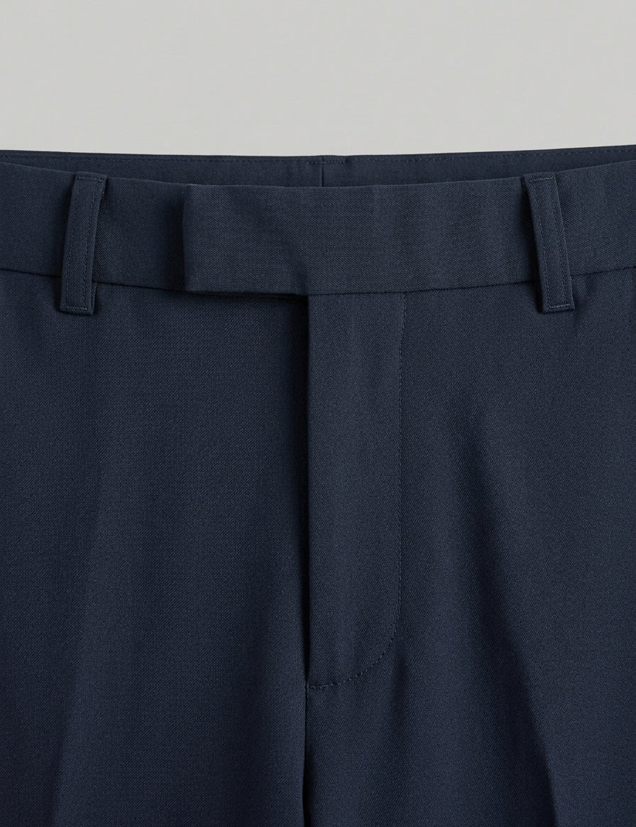 Navy blue pants with a belt on a light gray background