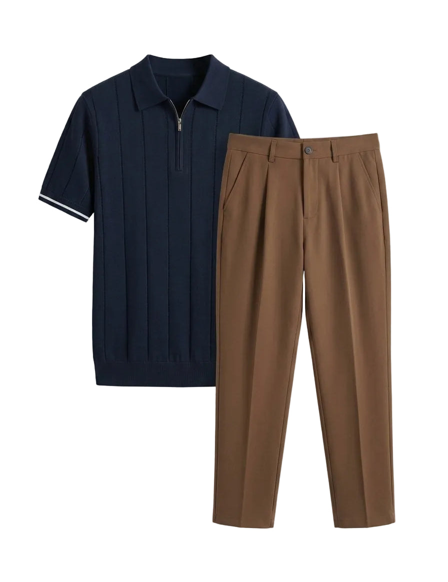 Navy polo shirt and brown pleated pants on a light gray background