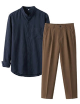 Navy shirt and brown pants on a light gray background