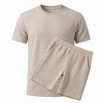 Olive green textured short-sleeve T-shirt with matching drawstring shorts on a white background.