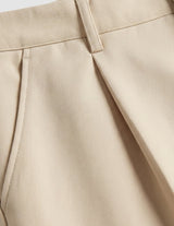 Olivo - Close-up of beige pants with a light gray background