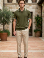 Olivo - Man wearing a green polo shirt and beige pants standing in an outdoor setting with stone walls and potted plants.
