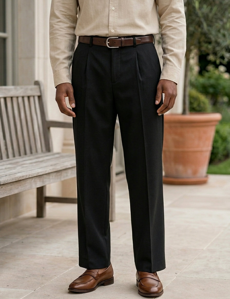 Person wearing a beige shirt, black pants, and brown shoes on a patio.