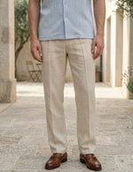 Person wearing beige pants and a light blue shirt outdoors on a stone path.