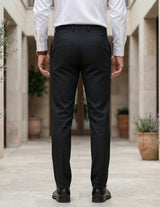 Person wearing black pants and a white shirt in an outdoor back view pant.