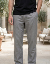 Person wearing gray pants and a black shirt in an outdoor setting