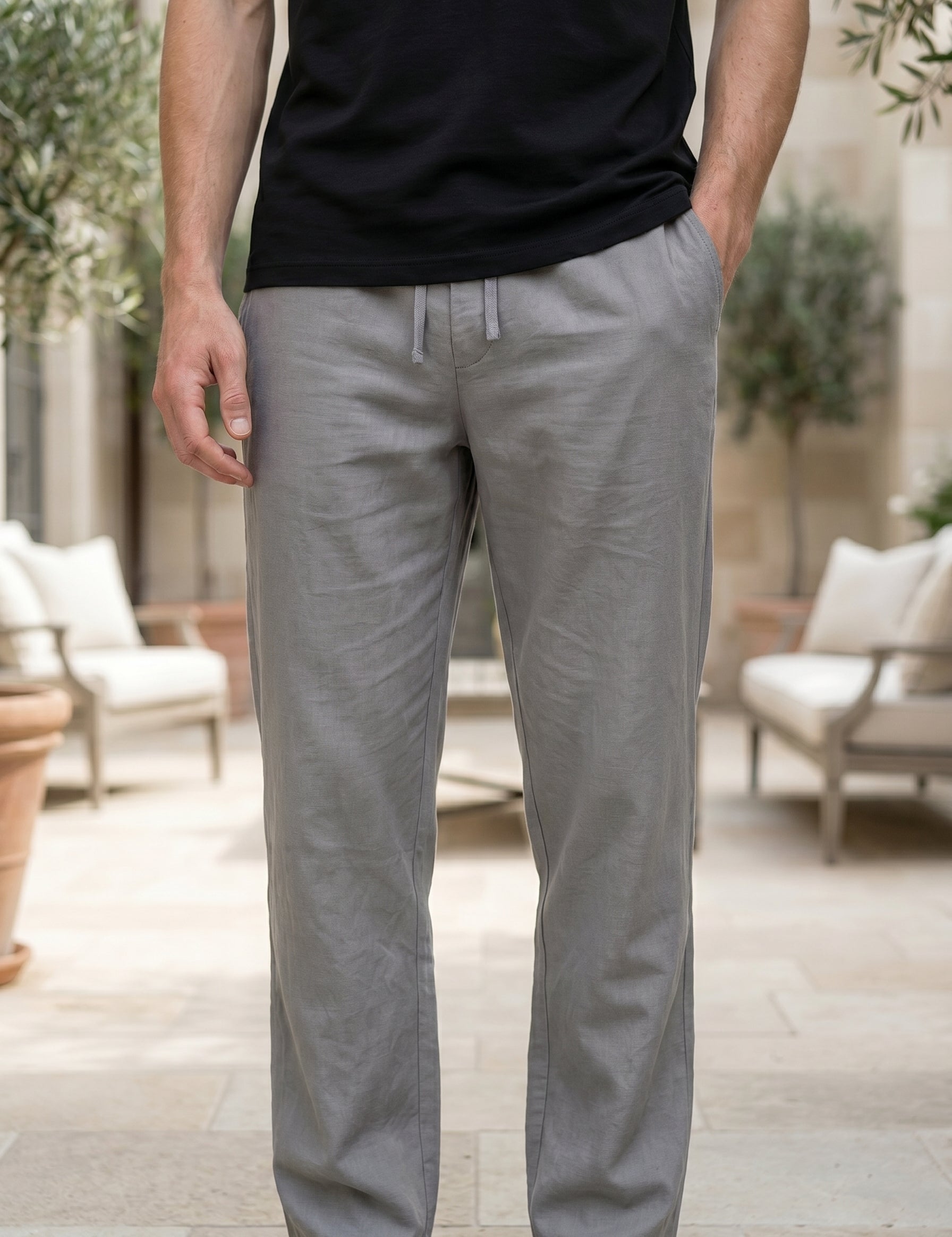 Person wearing gray pants and a black shirt in an outdoor setting