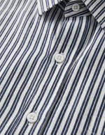 Close-up of a blue and white striped shirt with buttons.