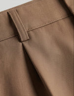Rosato - Close-up of brown pants with a belt on a light gray background