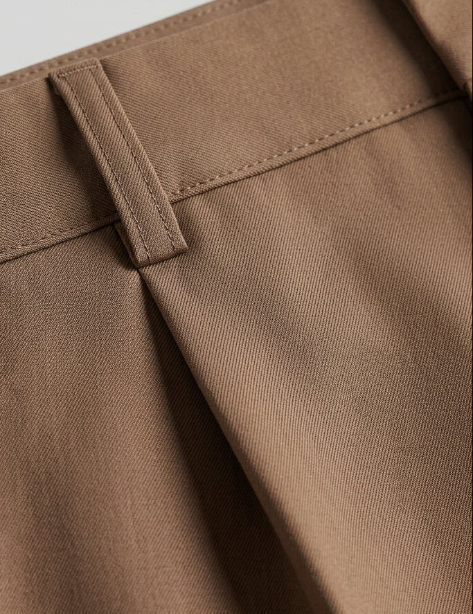 Rosato - Close-up of brown pants with a belt on a light gray background