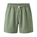 Sage green drawstring summer shorts with elastic waistband on a white background.