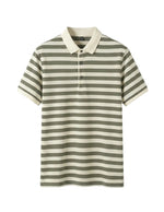 Striped polo shirt with green and white stripes on a gray background