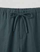 Teal pants with a drawstring waist on a light gray background