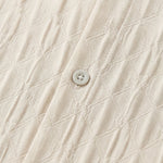 Top fabric detail - Soft cream men’s embossed collared long sleeve shirt