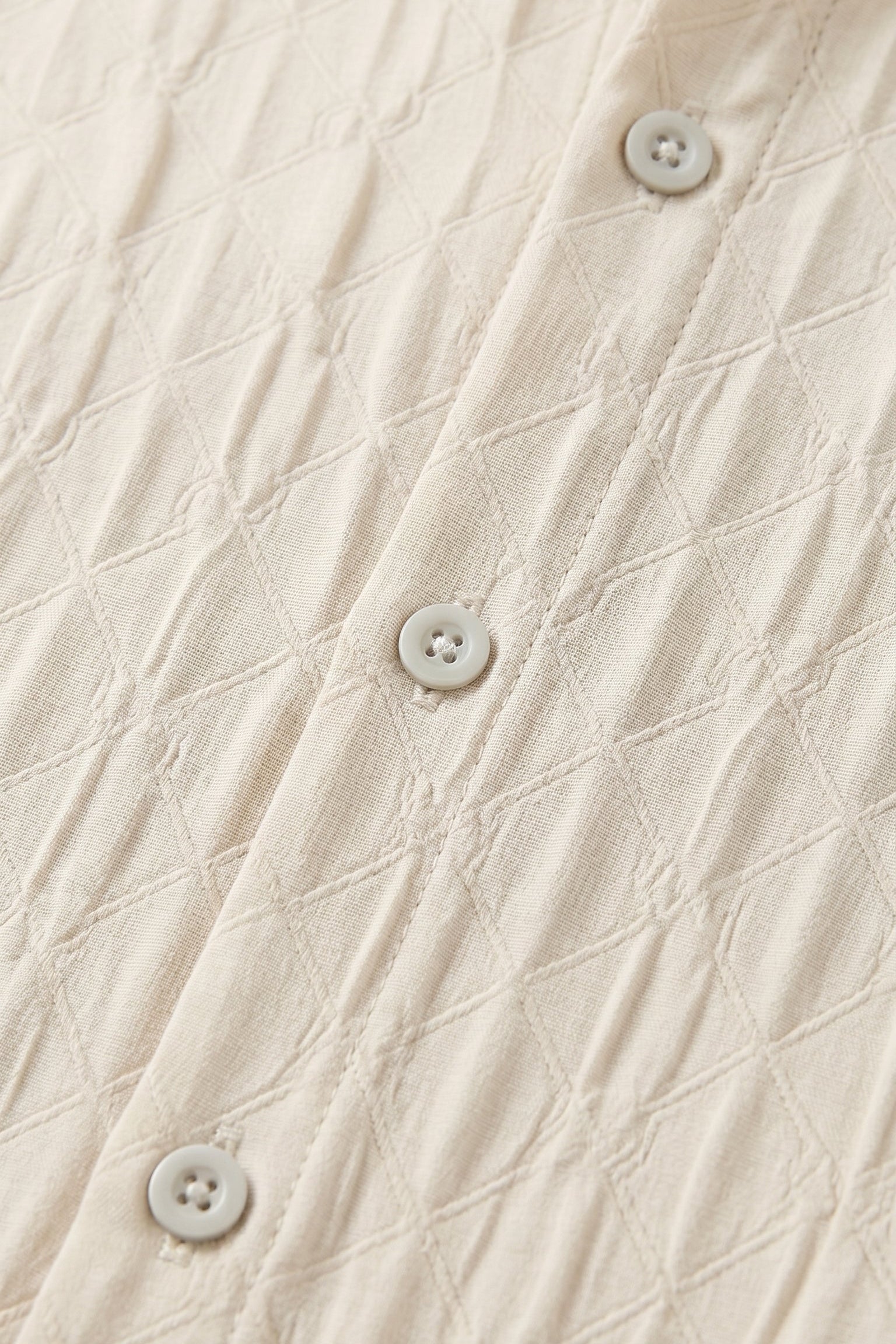 Top fabric detail - Soft cream men’s embossed collared long sleeve shirt