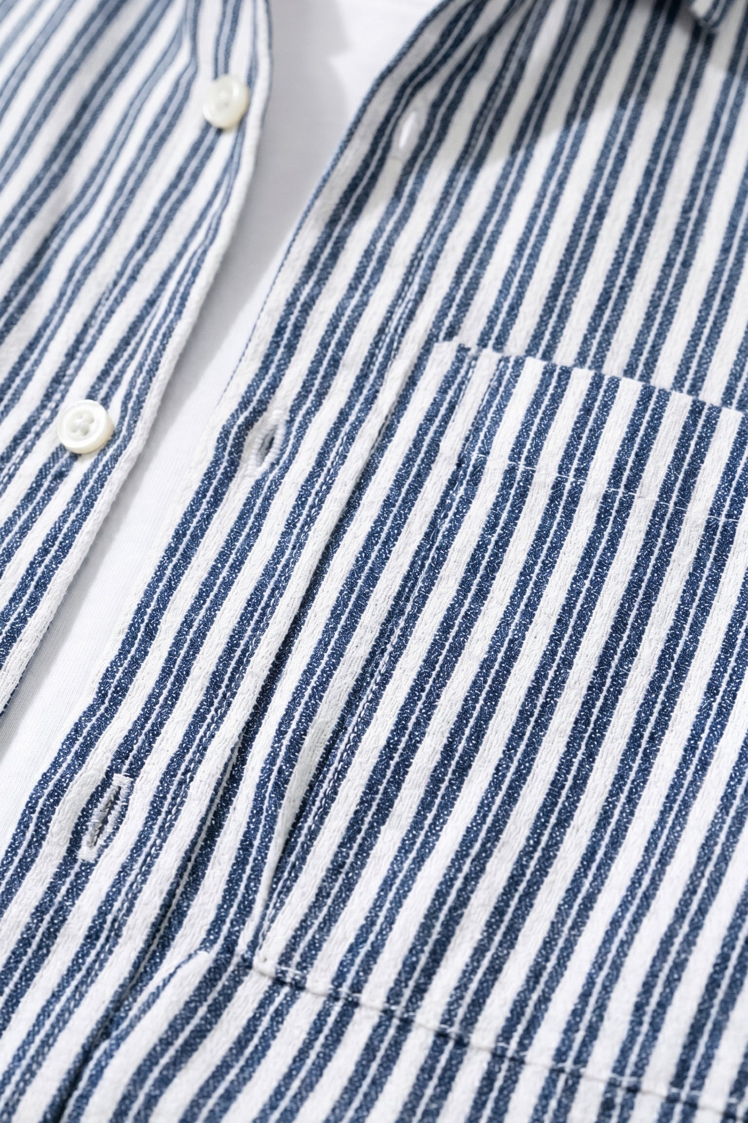Top fabric detail - Navy and white striped men’s cotton-blend button-up shirt