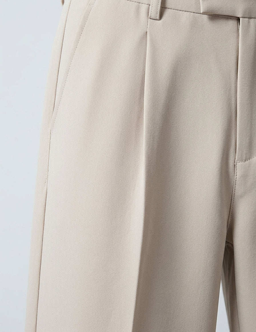 Close-up of beige pants on a light gray background