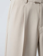 Close-up of beige pants on a light gray background