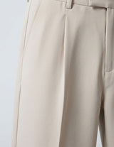 Close-up of beige pants on a light gray background