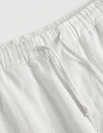 White pants with a belt on a white background