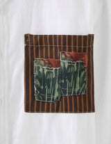 White shirt with a patch featuring brown stripes and green fabric on a white background
