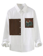 White shirt with brown and patterned patch on a white background
