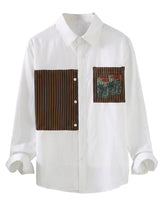 White shirt with brown and patterned patch on a white background