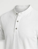 White short-sleeve shirt with button details on a light gray background