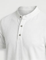 White short-sleeve shirt with button details on a light gray background