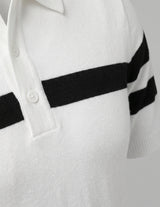 White sweater with black stripes on the sleeves against a light gray background