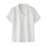 White textured short-sleeve button-up summer shirt with camp collar and chest pocket on a white background.