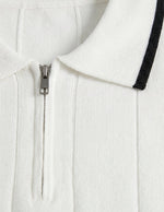 White zip-up hoodie with black trim on a light gray background