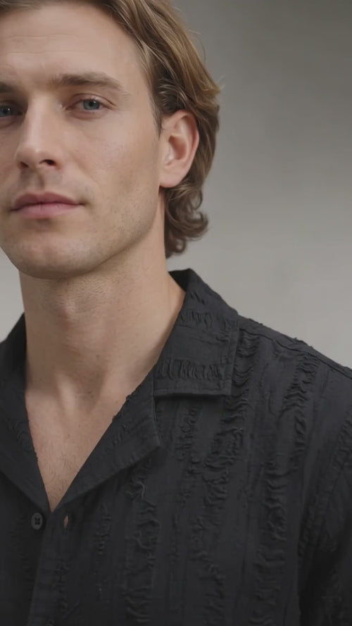 Model wearing black shirt in a video